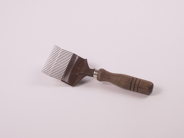 Uncapping fork with wooden handle.